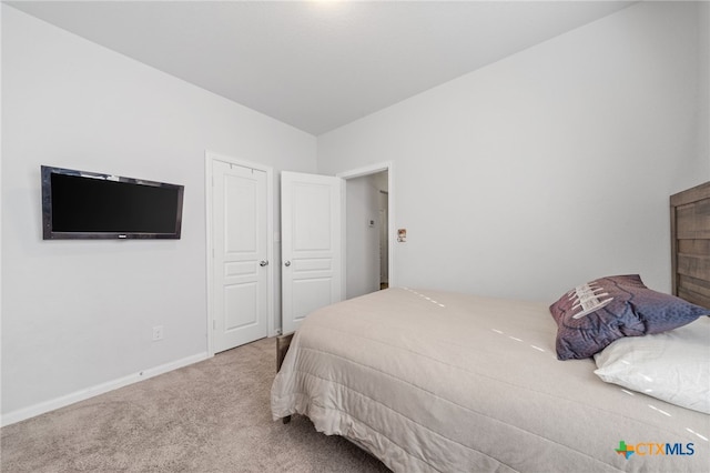 bedroom with carpet and baseboards