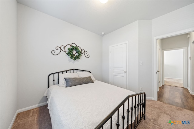 bedroom with baseboards and carpet floors