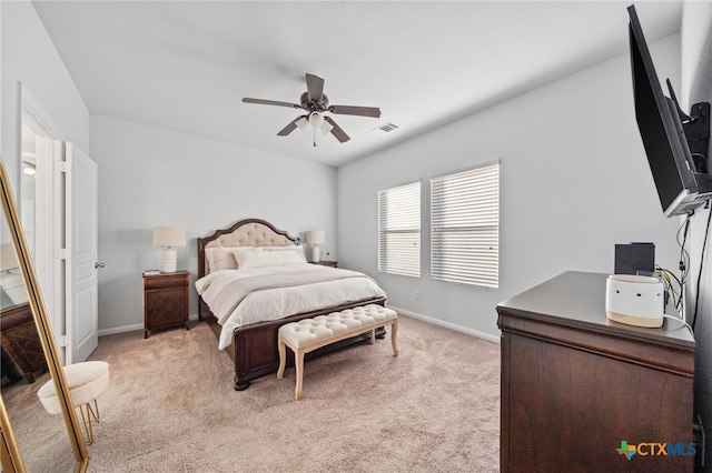 bedroom featuring visible vents, baseboards, light colored carpet, and a ceiling fan