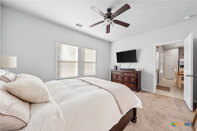 bedroom with baseboards, visible vents, light tile patterned flooring, ceiling fan, and light carpet