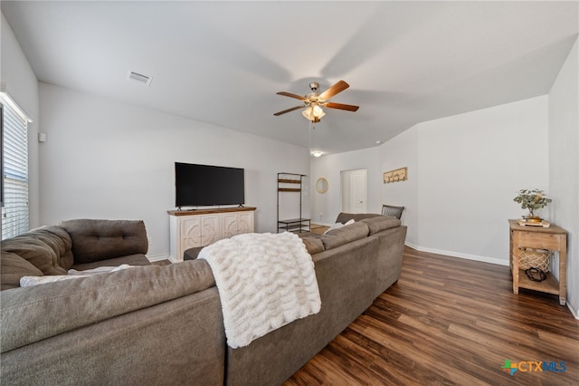 living room with visible vents, baseboards, dark wood-type flooring, and ceiling fan