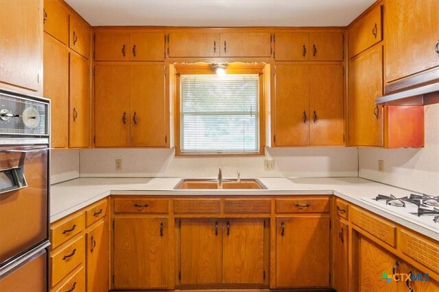 302 W Upshaw Ave, Temple, TX 76501 - kitchen featuring a sink, oven, light countertops, and white gas cooktop