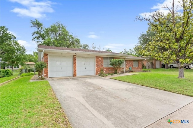 302 W Upshaw Ave, Temple, TX 76501 - ranch-style house featuring brick siding, an attached garage, driveway, and a front lawn