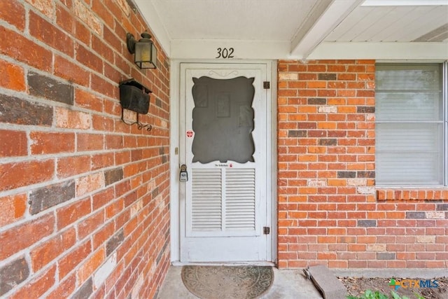302 W Upshaw Ave, Temple, TX 76501 - doorway to property featuring brick siding