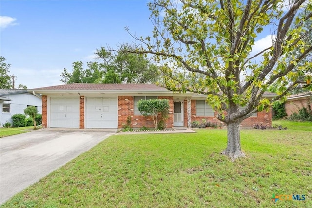 302 W Upshaw Ave, Temple, TX 76501 - single story home with an attached garage, driveway, brick siding, and a front lawn