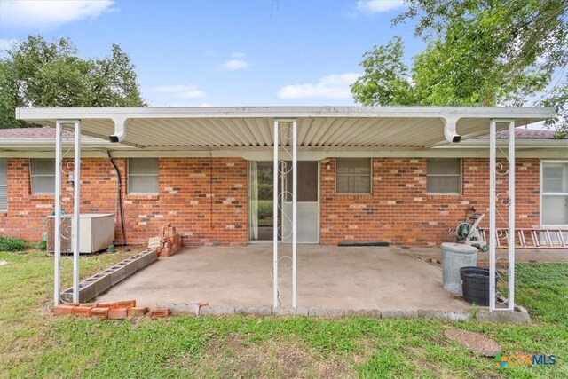 302 W Upshaw Ave, Temple, TX 76501 - back of property with brick siding and a patio area