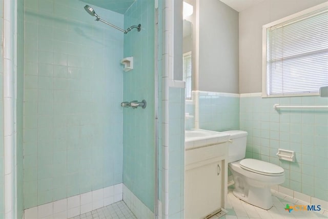 302 W Upshaw Ave, Temple, TX 76501 - bathroom featuring tile patterned floors, a shower stall, vanity, tile walls, and toilet