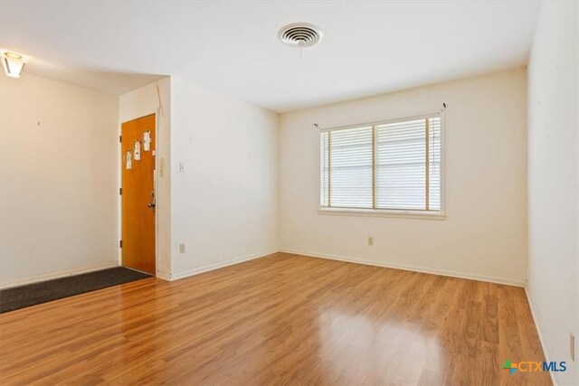 302 W Upshaw Ave, Temple, TX 76501 - spare room with wood finished floors and baseboards