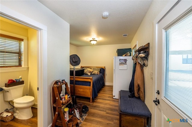 6589 State Highway 304, Harwood, TX 78632 - bedroom with wood finished floors and multiple windows