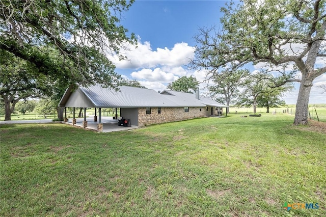 6589 State Highway 304, Harwood, TX 78632 - rear view of house with a lawn and metal roof