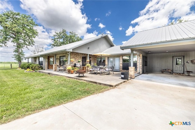 6589 State Highway 304, Harwood, TX 78632 - rear view of house with metal roof and stone siding