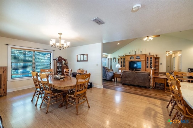 6589 State Highway 304, Harwood, TX 78632 - dining area featuring a chandelier, light wood-type flooring, lofted ceiling, ceiling fan, and baseboards