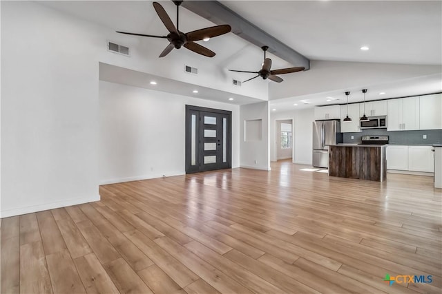 unfurnished living room featuring beamed ceiling, ceiling fan, high vaulted ceiling, and light wood-type flooring