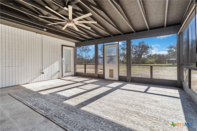 sunroom featuring vaulted ceiling and ceiling fan