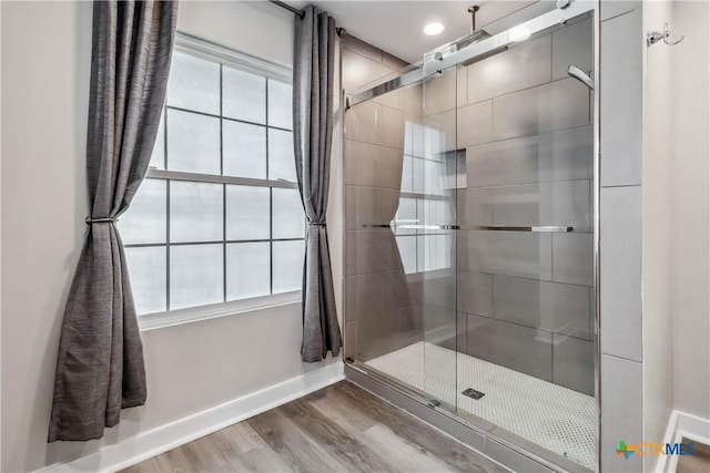 bathroom featuring hardwood / wood-style flooring and walk in shower