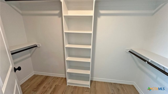 spacious closet with wood finished floors