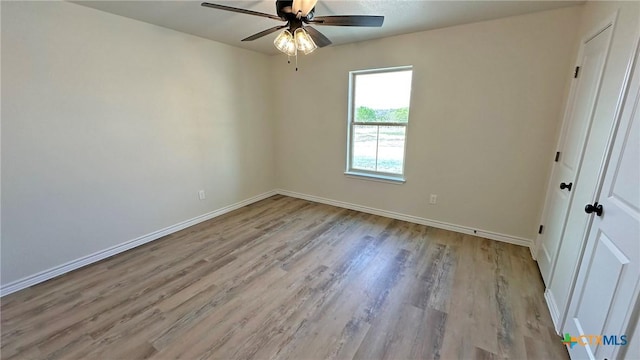 unfurnished bedroom with baseboards, wood finished floors, and ceiling fan