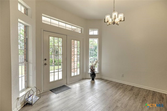 2109 Southport Dr, Killeen, TX 76542 - entryway with healthy amount of natural light, a chandelier, and wood finished floors