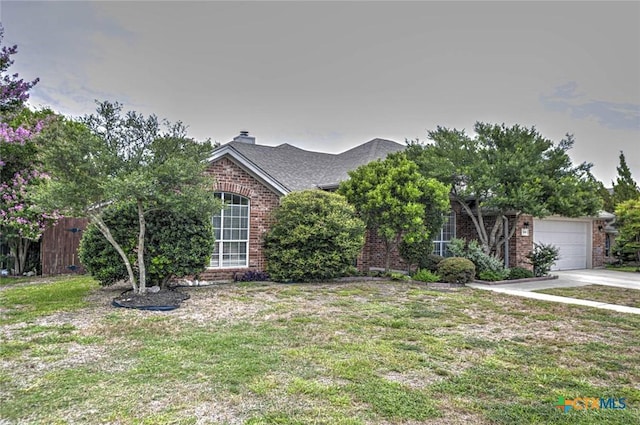 2109 Southport Dr, Killeen, TX 76542 - view of property hidden behind natural elements featuring brick siding, driveway, a garage, and a chimney