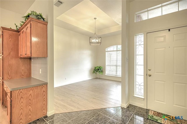 2109 Southport Dr, Killeen, TX 76542 - entryway with a tray ceiling and a chandelier