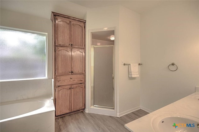 2109 Southport Dr, Killeen, TX 76542 - full bath featuring a shower stall, wood finished floors, a bath, and double vanity