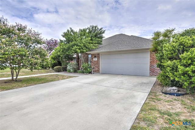 2109 Southport Dr, Killeen, TX 76542 - view of front of home featuring brick siding, driveway, a garage, and a shingled roof