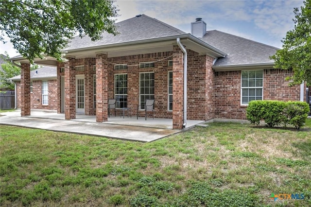 2109 Southport Dr, Killeen, TX 76542 - rear view of house with a patio area, brick siding, a chimney, and roof with shingles
