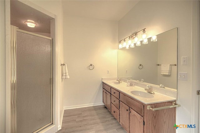 2109 Southport Dr, Killeen, TX 76542 - bathroom featuring double vanity, a stall shower, and wood finished floors