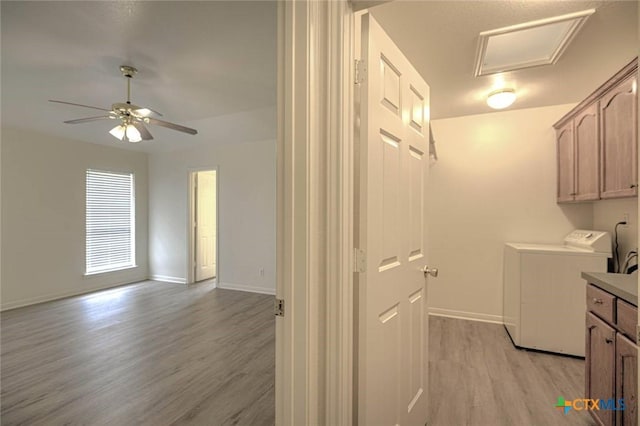 2109 Southport Dr, Killeen, TX 76542 - washroom with light wood-type flooring, ceiling fan, cabinet space, and washer and clothes dryer