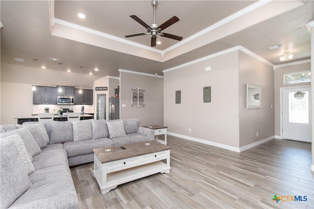 503 Willow Dr, Troy, TX 76579 - living room featuring ceiling fan, light wood-style flooring, a tray ceiling, ornamental molding, and recessed lighting