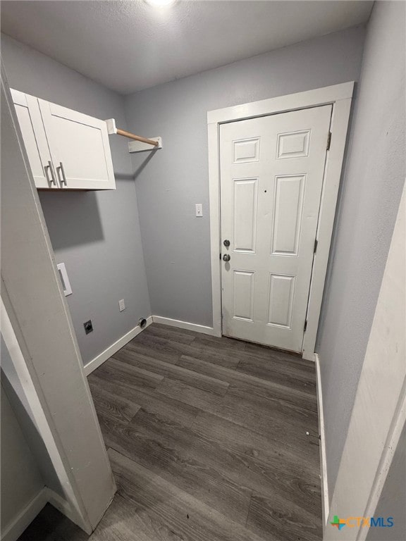 1803 E Leon St, Gatesville, TX 76528 - washroom featuring cabinet space, dark wood-style flooring, baseboards, and hookup for an electric dryer