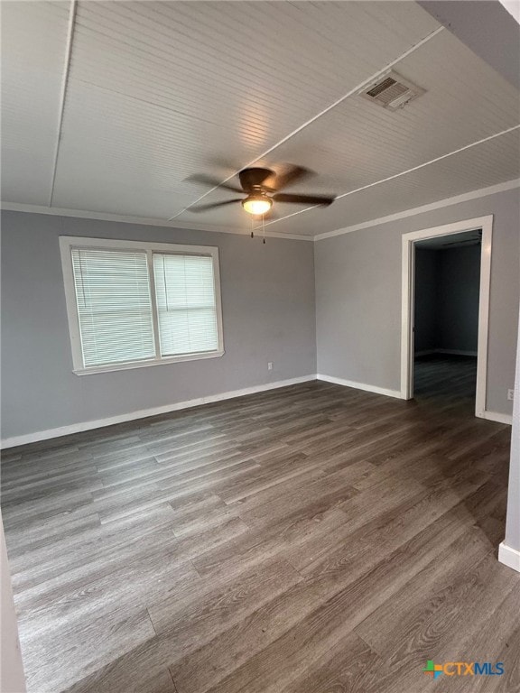 1803 E Leon St, Gatesville, TX 76528 - empty room featuring baseboards, a ceiling fan, dark wood-type flooring, and ornamental molding