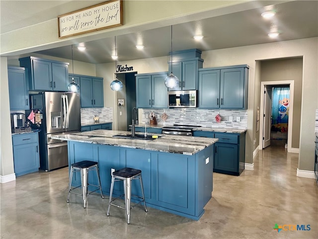 kitchen with a kitchen breakfast bar, a kitchen island with sink, appliances with stainless steel finishes, and blue cabinets