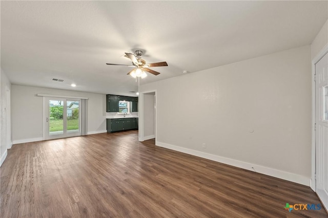 3126 Glenwood Dr, Temple, TX 76502 - unfurnished living room with visible vents, ceiling fan, baseboards, and dark wood-style floors