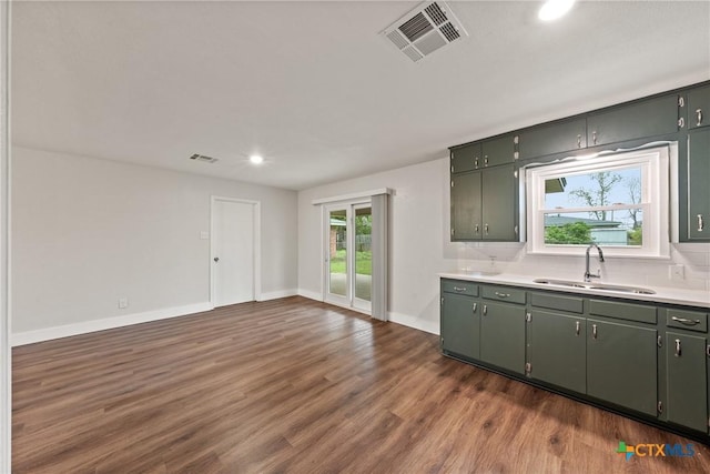 3126 Glenwood Dr, Temple, TX 76502 - kitchen with dark wood-style flooring, baseboards, recessed lighting, visible vents, and a sink