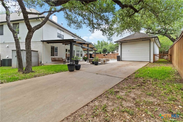 3836 Newland Ct, Round Rock, TX 78681 - view of front of home with a chimney, fence, a garage, cooling unit, and concrete driveway