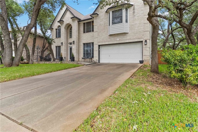 3836 Newland Ct, Round Rock, TX 78681 - french country home with a garage, driveway, and brick siding