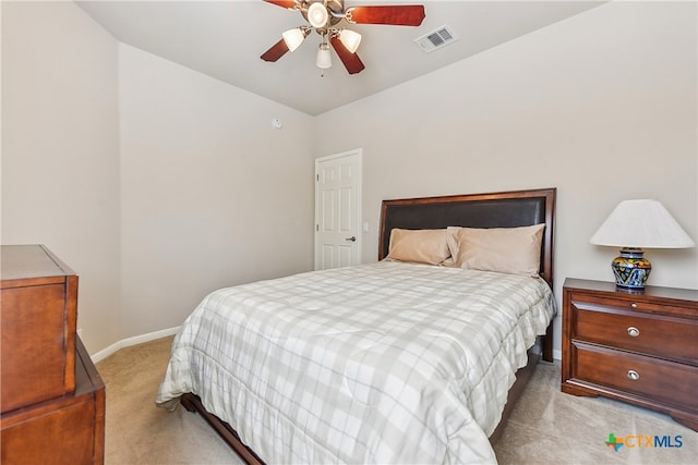 carpeted bedroom with ceiling fan and vaulted ceiling