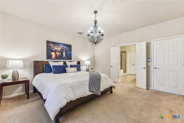 carpeted bedroom with a chandelier