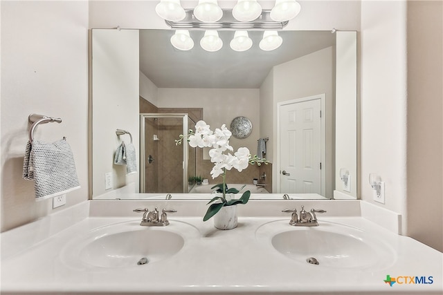 bathroom with vanity and a shower with door