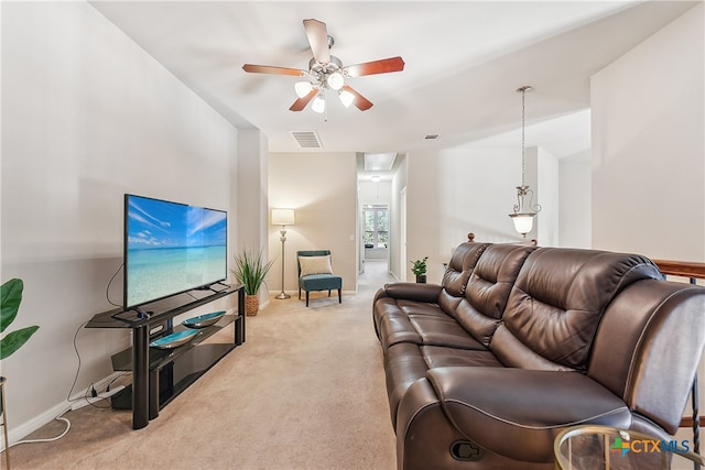 carpeted living room with ceiling fan and vaulted ceiling