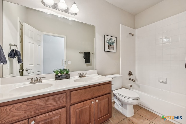 full bathroom featuring tile patterned floors, vanity, tiled shower / bath combo, and toilet