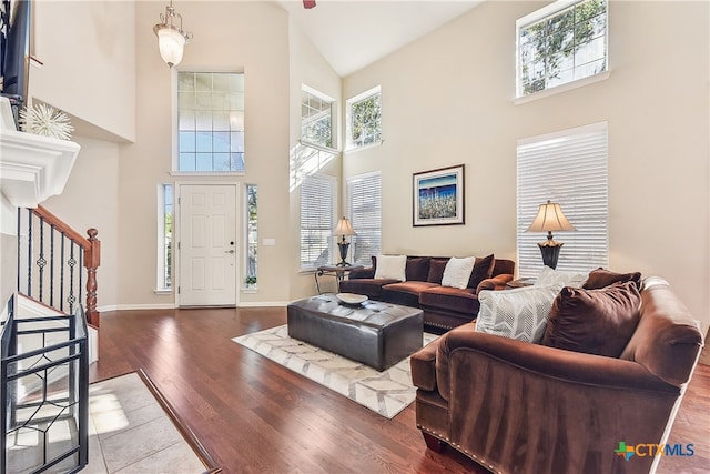 living room featuring hardwood / wood-style floors and high vaulted ceiling