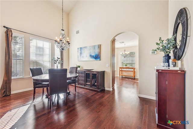 dining area with dark hardwood / wood-style flooring and high vaulted ceiling