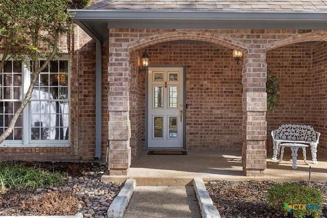 2113 Highland Dr, Salado, TX 76571 - doorway to property featuring brick siding and roof with shingles