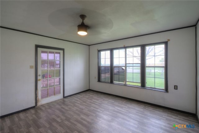 unfurnished room featuring hardwood / wood-style flooring, ceiling fan, and crown molding