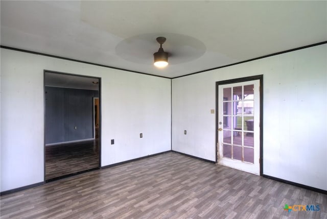 unfurnished room featuring hardwood / wood-style flooring, ceiling fan, and crown molding