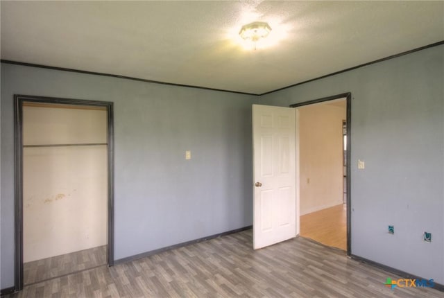 unfurnished bedroom with a closet and hardwood / wood-style floors