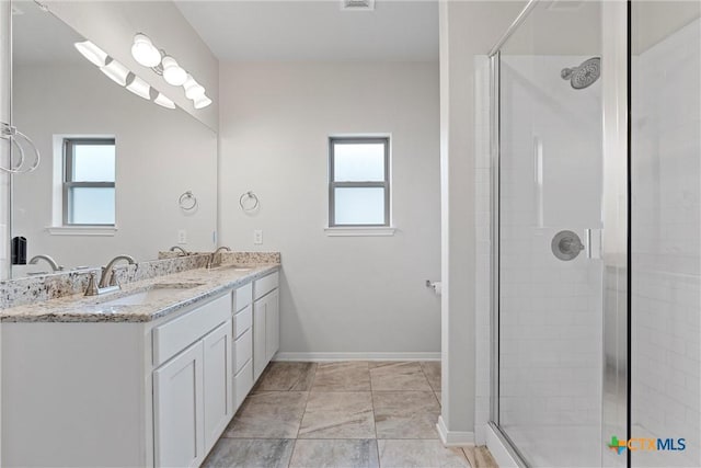 1332 Lakeway Crossing Dr, Temple, TX 76502 - bathroom with a stall shower, double vanity, healthy amount of natural light, and baseboards