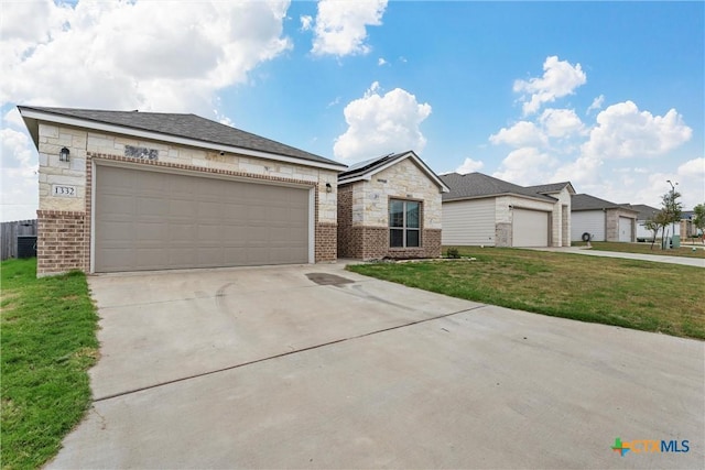 1332 Lakeway Crossing Dr, Temple, TX 76502 - view of front of house with a front yard, brick siding, driveway, central AC, and stone siding